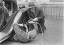 Radio reporter Alexis af Enehjelm interviewing a man fixing a car, 1930s IMG